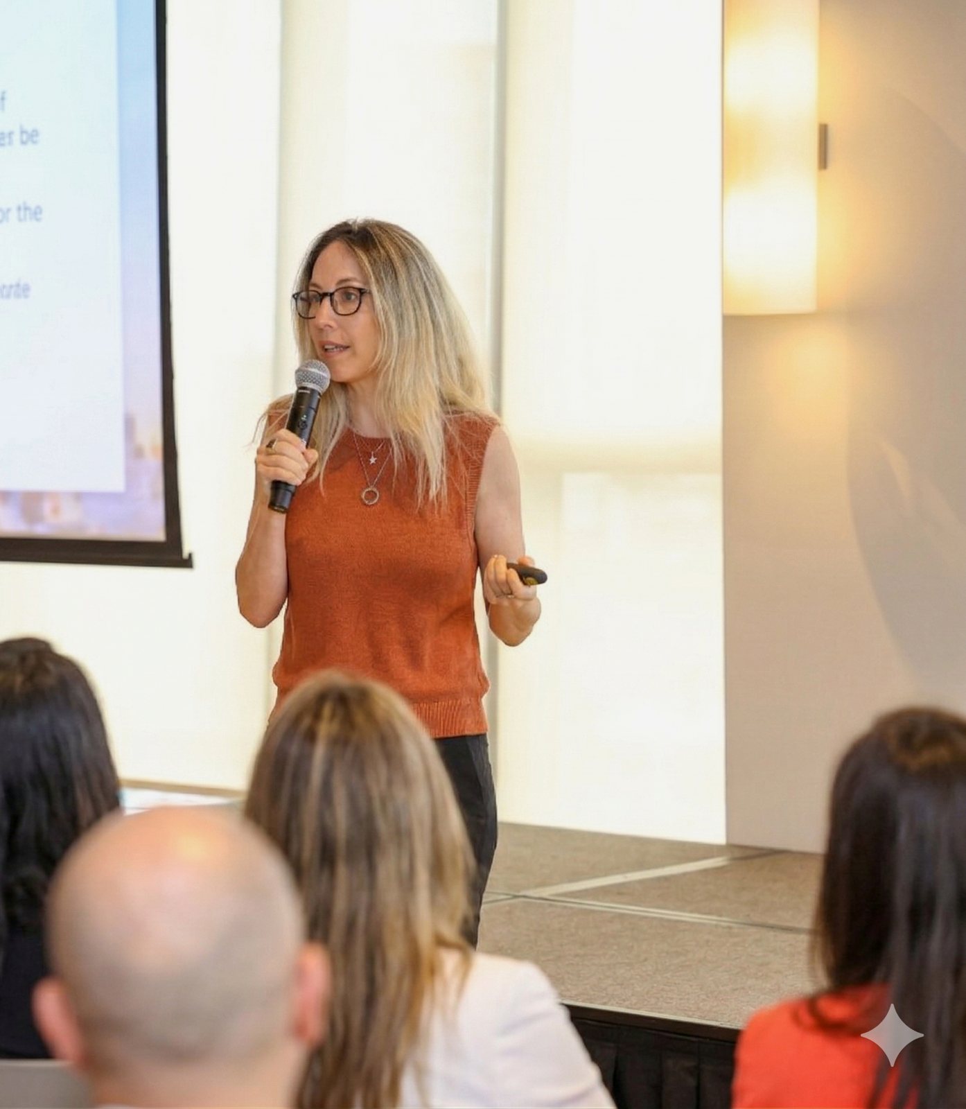 Shani Burshtein speaking on stage